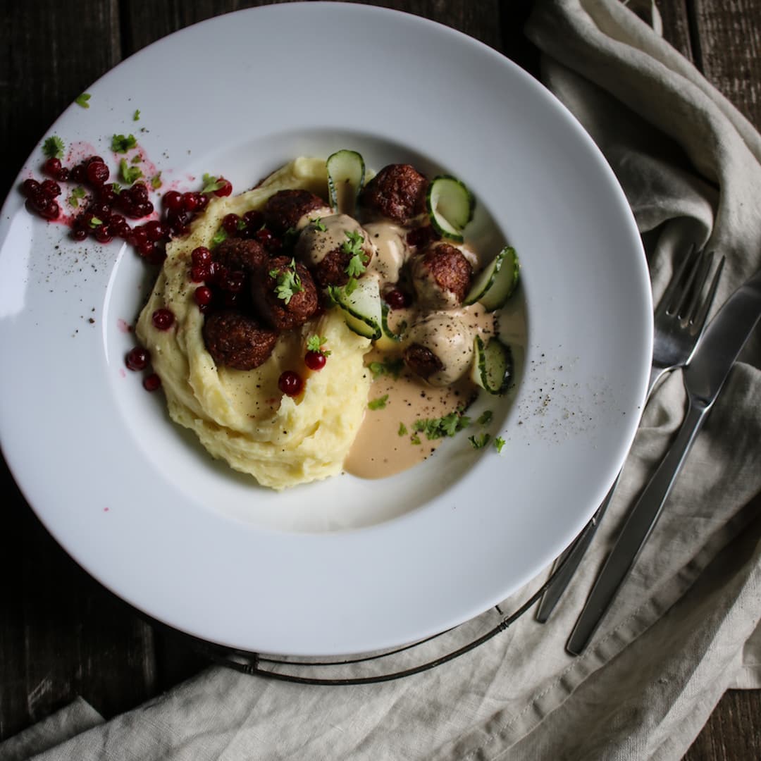 Ärtbollar med potatispuré, rostad vitpeppargräddsås, pressgurka, rårörda lingon och persilja